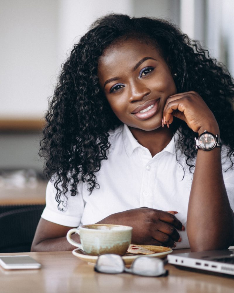 African american business woman with computer and coffee