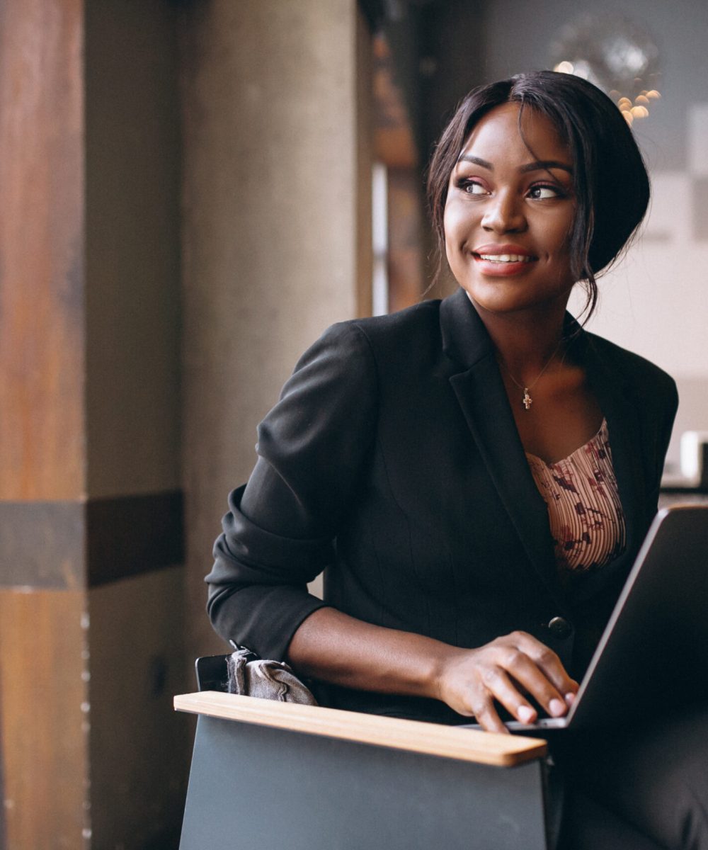 African american business woman working on a computer in a bar